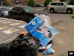 Posters of women candidates for parliamentary elections are found dumped in the garbage in Baghdad, Iraq, April 21, 2018.