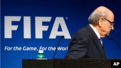 FILE - FIFA President Sepp Blatter is seen leaving a podium.