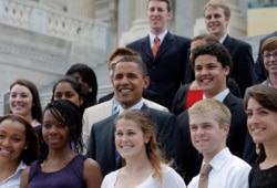 Democratic presidential candidate Sen. Barack Obama, D-Ill., center, poses for photos with Senate interns, Wednesday, July 9, 2008, on Capitol Hill in Washington.