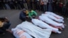 Palestinians mourn their relatives killed in the Israeli bombardment of Maghazi in the Gaza Strip, during their funeral at a hospital morgue in Deir al-Balah, Gaza, Nov. 14, 2024. 