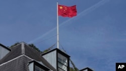 FILE - A Chinese national flag flies above China's Embassy in London, Sept. 11, 2023.