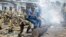 Police and army clear barricades set by opposition demonstrators in the Cibitoke district of the capital Bujumbura, in Burundi, May 25, 2015. 