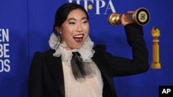 Awkwafina poses in the press room with the award for best performance by an actress in a motion picture, musical or comedy for "The Farewell" at the 77th annual Golden Globe Awards Sunday, Jan. 5, 2020. (AP Photo/Chris Pizzello)