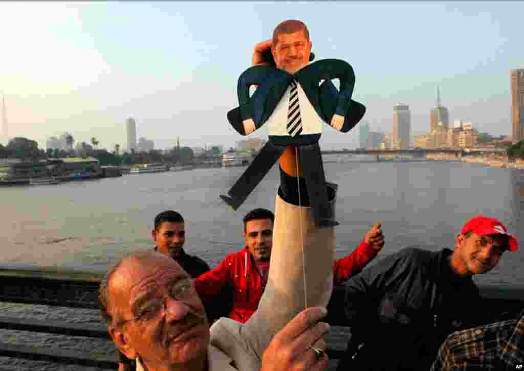 Egyptian artist Mohammed Darwish with a puppet of President Mohamed Morsi during an anti-Muslim Brotherhood protest on Qasr El-Nile Bridge in Cairo, February 10, 2013.