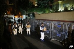 Turkish forensic officers leave the Saudi consulate after they conducted a new search over the disappearance and alleged slaying of writer Jamal Khashoggi, in Istanbul, Oct. 18, 2018.