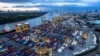 FILE - Containers await transport at a port along Chao Phraya River in Bangkok, Thailand, July 19, 2022. 