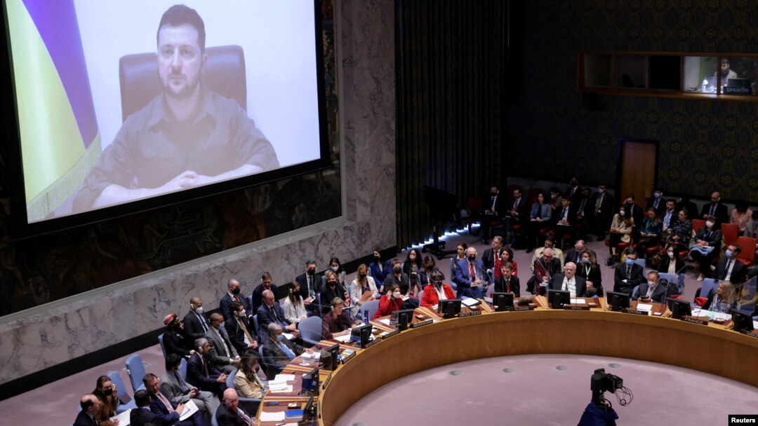 Ukrainian President Volodymyr Zelenskiy appears on a screen as he addresses the United Nations Security Council via video link during a meeting at the United Nations Headquarters in Manhattan, New York City, New York, U.S., April 5, 2022.