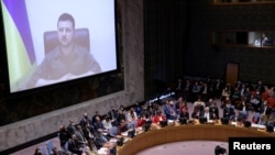 Ukrainian President Volodymyr Zelenskiy appears on a screen as he addresses the United Nations Security Council via video link during a meeting at the United Nations Headquarters in Manhattan, New York City, New York, U.S., April 5, 2022.