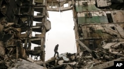 A resident looks for belongings in an apartment building destroyed during fighting between Ukrainian and Russian forces in Borodyanka, Ukraine, April 5, 2022.