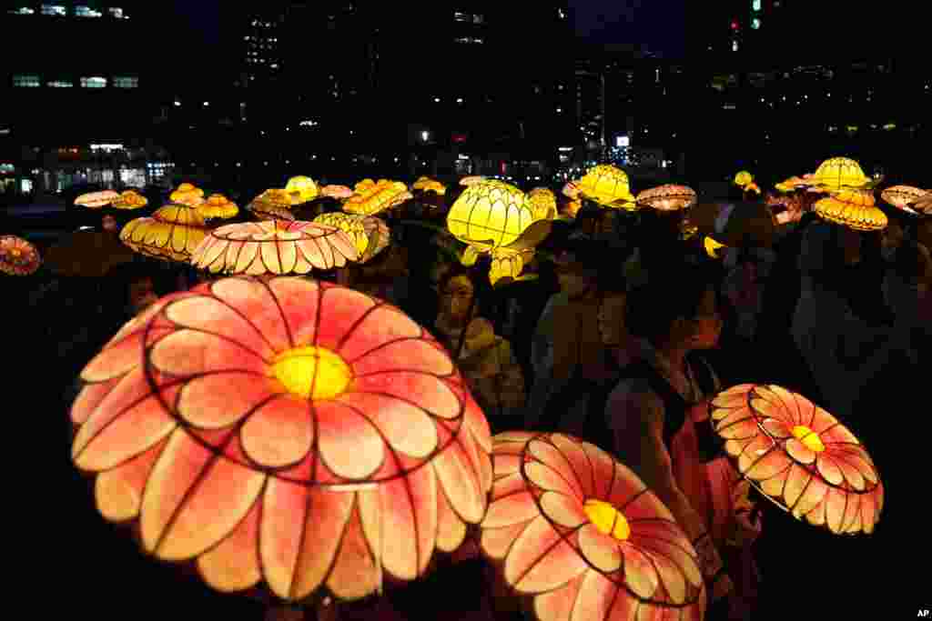 South Korean Buddhists wearing face coverings carry colorful lotus lanterns during a lighting ceremony in Seoul to celebrate the birthday&nbsp;of Buddha&nbsp;on May 8.