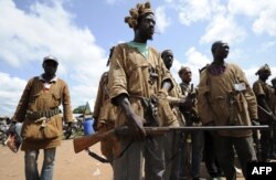 FILE - Traditional Ivorian Dozos gather in Kani, Ivory Coast, Sept. 27, 2013.