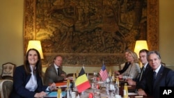 U.S. Secretary of State Antony Blinken, right, and Belgian Foreign Minister Sophie Wilmes, left, pose for a photo as they meet at Egmont Palace in Brussels, Belgium, April 6, 2022.