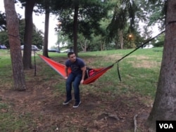 Seth Burt, an economics major at Ohio State University, relaxes in his hammock for a midday study session. Burt voted Republican in the 2012 presidential election. This year he won't vote. (C. Presutti/VOA)