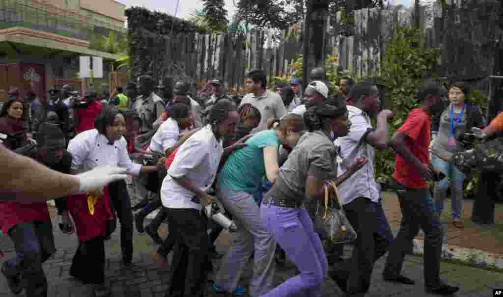 Civilians who had been hiding inside during the gun battle manage to flee from the Westgate Mall in Nairobi, Sept. 21, 2013.