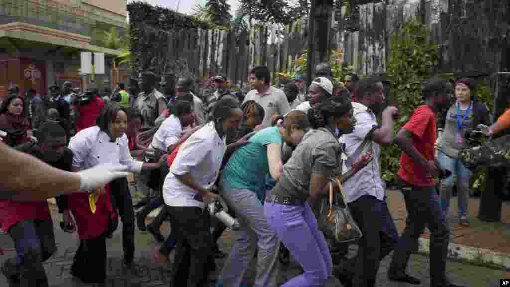 Civilians who had been hiding inside during the gun battle manage to flee from the Westgate Mall in Nairobi, Sept. 21, 2013.