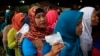 Villagers line up to vote in the country's presidential election at Bojong Koneng polling station in Bogor, Indonesia, July 9, 2014.