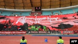 FILE—Football ultra supporters of Tunisian Club Africain display a huge sign during a CAF confederation cup group stage match against Angola's Academica Petroleos do Lobito at the Hammadi Agrebi Stadium in Tunis on March 3, 2024.