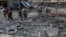 Hình tư liệu - Người dân kiểm tra hiện trường bị tấn công sau vụ không kích ở thành phố Idlib, ngày 18/1/2017. 