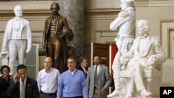 House Speaker-in-waiting John Boehner, of Ohio, center, Republican Majority Transition Chairman Rep. Greg Walden, R-Ore., second from left, and others walk to a news conference on Capitol Hill in Washington, 10 Nov 2010