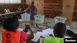 FILE: A woman casts her vote at a primary school in Glen Norah