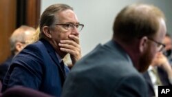 Defense attorney Franklin Hogue watches a video clip the jury asked to see as part of their deliberation during the trial of Greg McMichael, his son Travis McMichael, and neighbor, William 'Roddie' Bryan, Nov. 24, 2021, in Glynn County Court, in Brunswick, Ga.