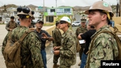 U.S. Marines and Navy corpsmen attached to the 26th Marine Expeditionary Unit and sailors assigned to Amphibious Construction Battalion 2 speak with local civilian employees during an assessment of Hospital Oriente’s needs as part of Hurricane Maria relief efforts in Humacao, Puerto Rico on Sept. 27, 2017.