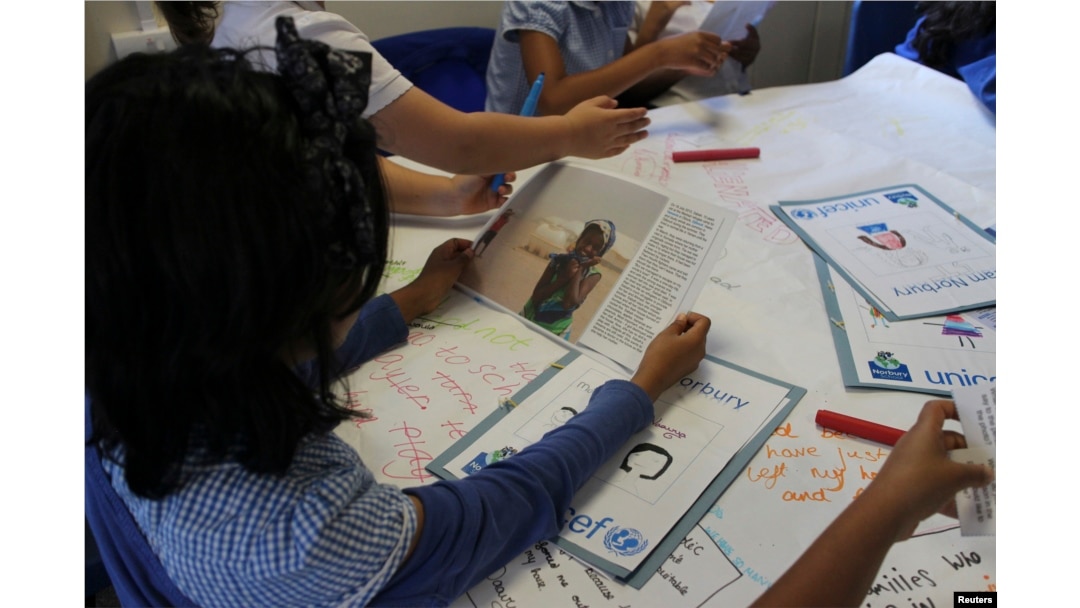 FILE - Primary school children take part in classroom lesson at Norbury School in Harrow, London, Britain, July 15, 2016.