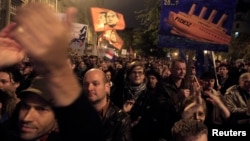 An injured woman reacts at a site hit by airstrikes in the rebel held area of Old Aleppo, Syria.