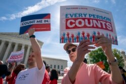 FILE - Activists rally outside the Supreme Court as the justices hear arguments over the Trump administration's plan to ask about citizenship on the 2020 census, in Washington, April 23, 2019.