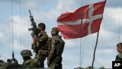 Danish soldiers participate in the annual multinational NATO exercise in the Baltic states on June 17, 2014.