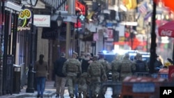 Military personnel walk down Bourbon street in New Orleans, Jan. 2, 2025. 