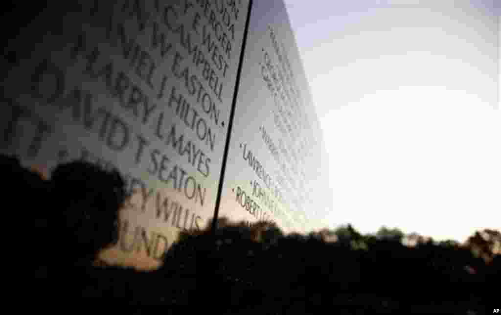 The Vietnam Veterans Memorial Wall is seen as the Sun rises on the 50th anniversary of the Vietnam War, Monday, May 28, 2012, on Memorial Day in Washington. (AP Photo/Carolyn Kaster)