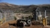 An Israeli military vehicle enters Syria at the ceasefire line by Syria and the Israeli-occupied Golan Heights, after the ousting of Syria's Bashar al-Assad, as seen from Majdal Shams in the Golan Heights