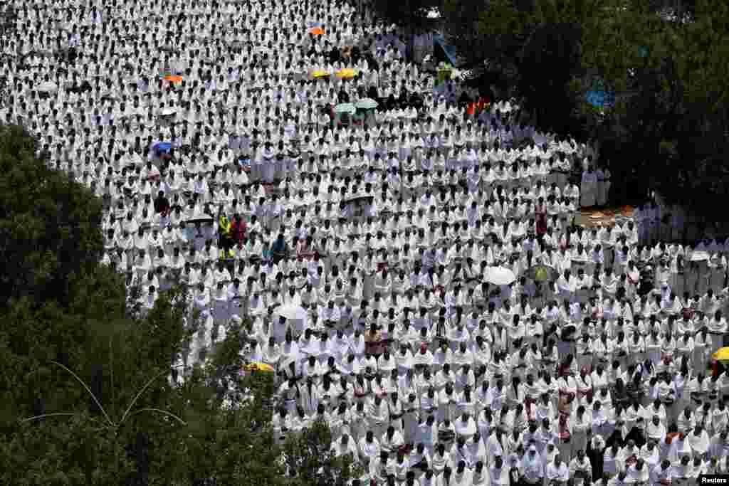 Muslim pilgrims pray outside Namira Mosque on the plains of Arafat during the annual haj pilgrimage, outside the holy city of Mecca, Saudi Arabia, Aug. 10, 2019.