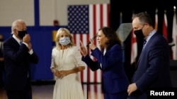 From left, Democratic presidential candidate Joe Biden, his wife, Jill Biden, vice presidential candidate Kamala Harris and her husband, Douglas Emhoff, at Alexis Dupont High School in Wilmington, Delaware, Aug. 12, 2020.