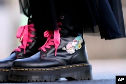 A visitor wears boots featuring Hello Kitty at the National Museum during the exhibition "As I change, so does she," marking the 50th anniversary of Hello Kitty at the Tokyo National Museum in Tokyo, Oct. 30, 2024.