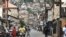 FILE .—People walk through a road in Freetown on June 18, 2023. Sierra Leone was calm today, November 27, 2023 after a weekend attack by gunmen on a military barracks.