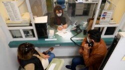 Mohammad Attaie and his wife Deena, newly arrived from Afghanistan, get assistance from medical translator Jahannaz Afshar making a doctor's appointment at the Valley Health Center TB/Refugee Program in San Jose, California on Dec. 9, 2021.