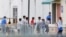FILE - In this June 20, 2018, file photo, immigrant children walk in a line outside the Homestead Temporary Shelter for Unaccompanied Children, a former Job Corps site that now houses them in Homestead, Florida.