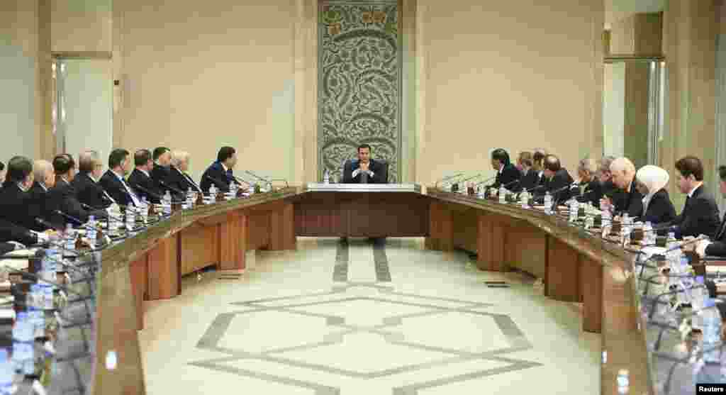 Syria's President Bashar al-Assad heads a meeting of his new cabinet in Damascus, Aug. 31, 2014 