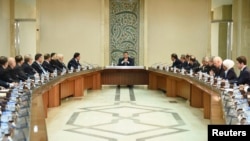 FILE - Syria's President Bashar al-Assad heads a meeting of his cabinet in Damascus.
