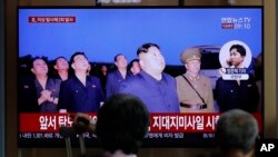 People watch a TV news program on North Korea's firing projectiles with a file image of North Korean leader Kim Jong Un at the Seoul Railway Station in Seoul, South Korea, Aug. 16, 2019. 