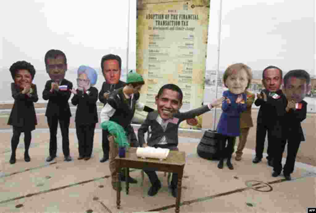 Oxam, activists wearing masks , left to right, of Brazilian President Dilma Rousseff , Russian President Dmitry Medvedev, Indian Prime Minister, Dr. Manmohan Singh, Britain's Prime Minister David Cameron, unidentified unmasked Oxfam activist, US presi