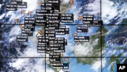 An electronic display shows live information of flight positions according to predicted time and flight duration calculations at the Kuala Lumpur International Airport, March 16, 2014 in Sepang, Malaysia.