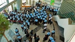 Police officers gather at the lobby of headquarters of Apple Daily in Hong Kong Thursday, June 17, 2021. (Apple Daily via AP)