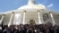 FILE - Deputies of Venezuelan coalition of opposition parties (MUD) pose for a picture in front of a giant picture of Venezuela's late President Hugo Chavez after a session of the National Assembly in Caracas, Jan. 5, 2016.