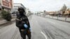 FILE - A security man stands in an empty street in Sulaimaniya, in Iraqi Kurdistan, March 14. 2020. 