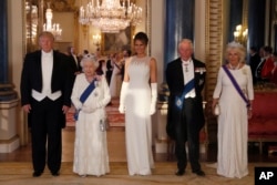 From left, US President Donald Trump, Britain's Queen Elizabeth II, first lady Melania Trump, Prince Charles and Camilla, the Duchess of Cornwall pose for the media ahead of the State Banquet at Buckingham Palace in London.