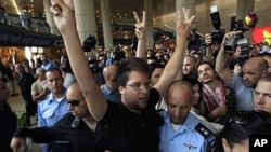Israeli police officers remove a pro-Palestinian Israeli activist during a small demonstration at the arrival terminal in Ben Gurion International Airport near Tel Aviv, July 8, 2011, in support of a "fly-in" by other pro-Palestinian activists to Tel Aviv