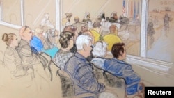 Family members of victims and Office of Military Commissions staff watch pretrial hearings for alleged conspirators in the 9/11 attacks, Guantanamo Bay, Cuba, Jan. 28, 2013.